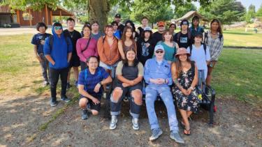 Group of Indigenous students sitting with Elder