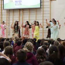 Bhangra Dancers performing in front of elementary students in gym